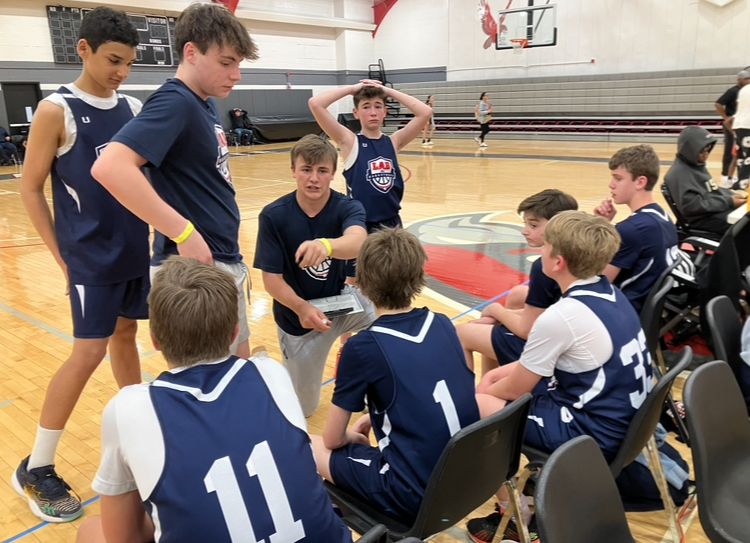 Coach with LAB Elite players during a game
